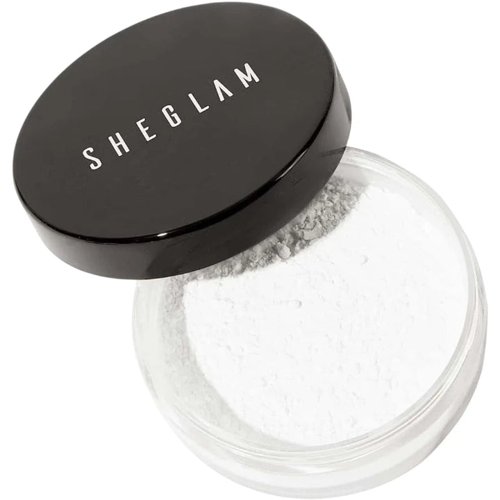 Sheglam loose powder with black lid on a white background